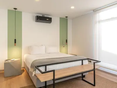a bedroom with a bed and a bench in it at NOK Fancy 3BR Balcony in Laureles Medellin in Medellín