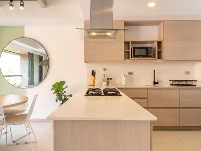 a kitchen with a white counter top and a mirror at NOK Fancy 3BR Balcony in Laureles Medellin in Medellín