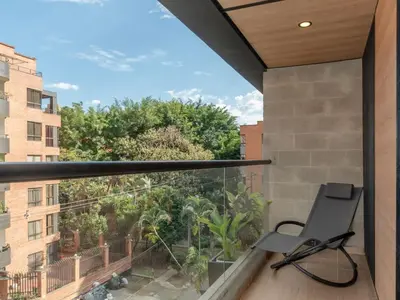 a balcony with a chair and a window at NOK Stylish 3BR in Laureles MDE in Medellín