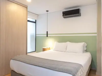 a bedroom with a large white bed and a window at NOK Stylish 3BR in Laureles MDE in Medellín
