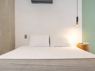 a large white bed in a room with at NOK Charming 3BR in Laureles Medellin in Medellín