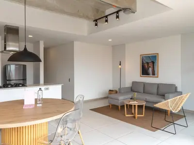 a living room with a couch and a table at NOK Charming 3BR in Laureles Medellin in Medellín