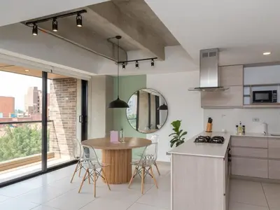 a kitchen with a table and chairs in a room at NOK Charming 3BR in Laureles Medellin in Medellín