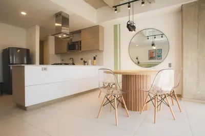 a kitchen with a table and two chairs and a mirror at NOK Amazing with Balcony 3 BR in Laureles Medellin in Medellín