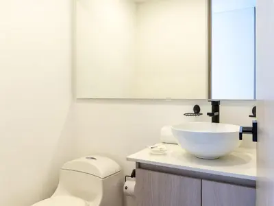 a bathroom with a toilet and a sink at NOK Lovely 3 BR with Balcony in Laureles Medellin in Medellín