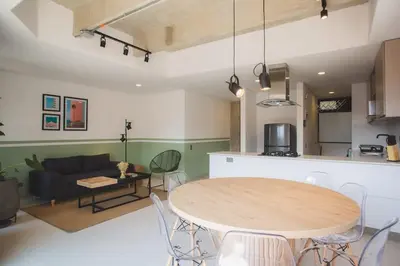 a kitchen and a living room with a table and chairs at NOK Cool 3 BR With Balcony in Laureles Medellin in Medellín