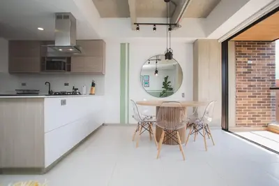 a kitchen and dining room with a table and chairs at NOK Cool 3 BR With Balcony in Laureles Medellin in Medellín