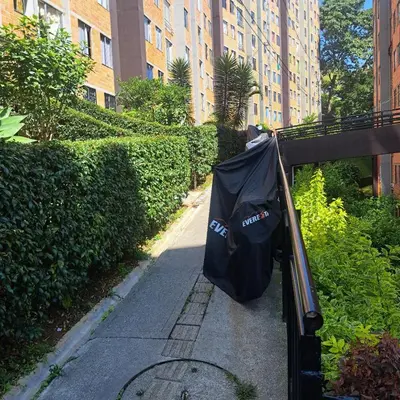 a trash can with an umbrella on the side of a sidewalk at Comodo apartamento con 2 habitaciones totalmente equipado para estancias largas in Medellín