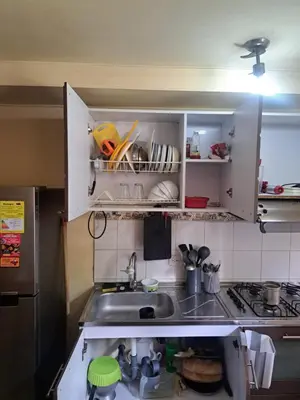 a small kitchen with a sink and a stove at Comodo apartamento con 2 habitaciones totalmente equipado para estancias largas in Medellín