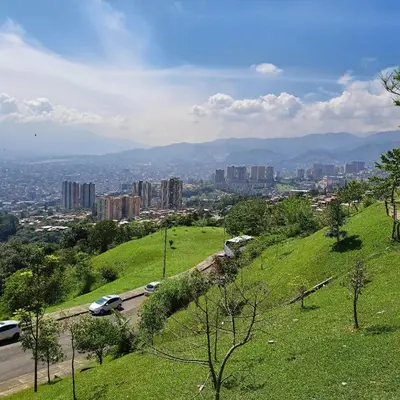 a view of a city from a hill with cars at Comodo apartamento con 2 habitaciones totalmente equipado para estancias largas in Medellín