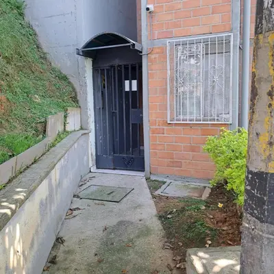 a black door on the side of a brick building at Comodo apartamento con 2 habitaciones totalmente equipado para estancias largas in Medellín