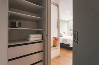 a door leading to a bedroom with a bed at Mountain Views, AC, King Bed, Fast WiFi in Medellín