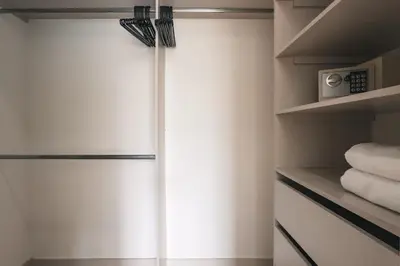 a bathroom with a sliding shower door and towels at Mountain Views, AC, King Bed, Fast WiFi in Medellín