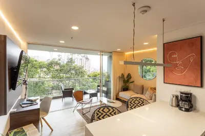 a kitchen and living room with a large window at Mountain Views, AC, King Bed, Fast WiFi in Medellín