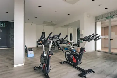 a gym with several exercise bikes in a room at Mountain Views, AC, King Bed, Fast WiFi in Medellín