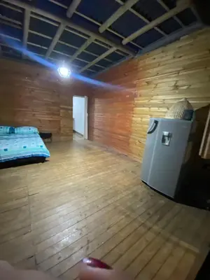 a room with a bed and a wooden floor at Refugio de Sueños in San Rafael