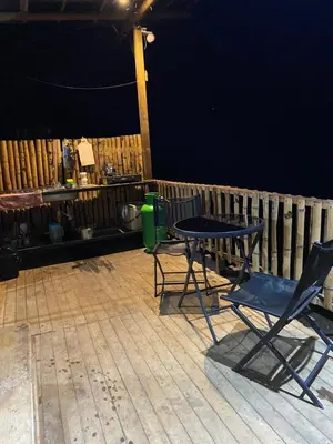 a patio with two chairs and a table and a fence at Refugio de Sueños in San Rafael