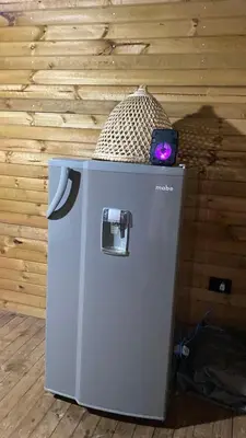 a refrigerator with a cell phone on top of it at Refugio de Sueños in San Rafael
