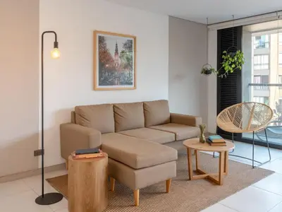 a living room with a couch and a table at NOK Bright 3BR with terrace in Laureles Medellin in Medellín