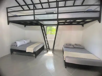 two beds in a room with a loft at Villa Serena Sopetran in Sopetran