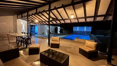 a living room with a pool and a table and chairs at Villa Serena Sopetran in Sopetran