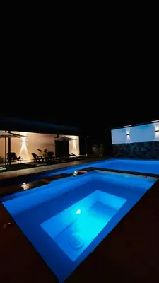 a swimming pool with blue lighting in a dark room at Villa Serena Sopetran in Sopetran