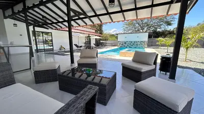 a patio with chairs and a table and a pool at Villa Serena Sopetran in Sopetran