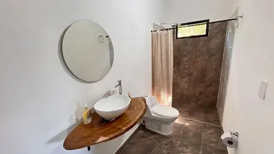 a bathroom with a sink and a toilet and a mirror at Villa Serena Sopetran in Sopetran
