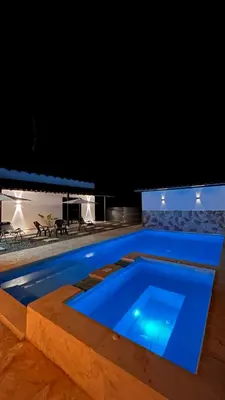 a swimming pool at night with blue lighting at Villa Serena Sopetran in Sopetran