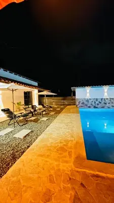 a night view of a patio with a table and an umbrella at Villa Serena Sopetran in Sopetran