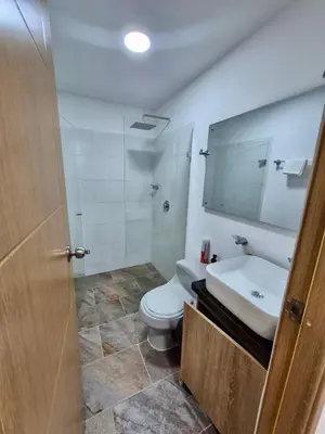a bathroom with a toilet and a sink and a mirror at Apartamento Oasis in Sopetran
