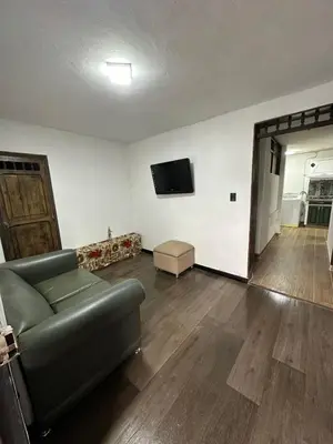 a living room with a couch and a flat screen tv at Hermoso apartamento en la milagrosa in Medellín