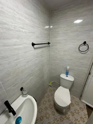 a bathroom with a toilet and a sink and a tub at Hermoso apartamento en la milagrosa in Medellín