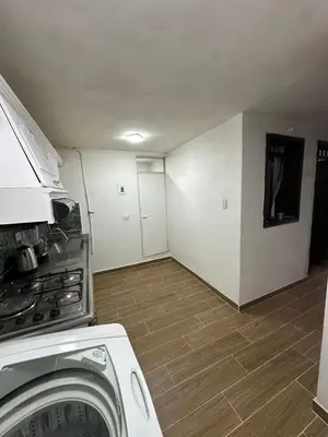 a kitchen with a washing machine and a washer at Hermoso apartamento en la milagrosa in Medellín