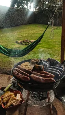 a grill with a bunch of hot dogs on it at Alcoba independiente en nuestro hogar santa Elena encantada in Santa Elena