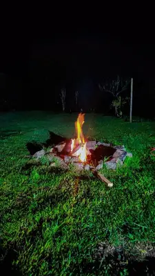 a fire in the grass in a field at night at Alcoba independiente en nuestro hogar santa Elena encantada in Santa Elena