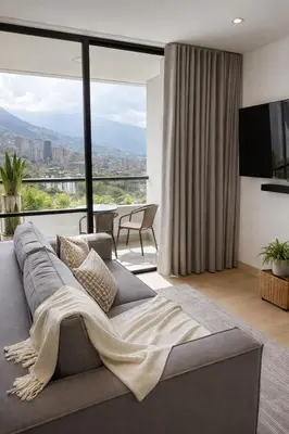 a living room with a couch and a large window at Monaco by Top Location City View in Medellín