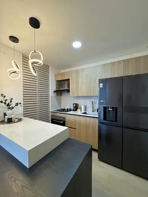 a kitchen with a black refrigerator and a counter at Monaco by Top Location City View in Medellín