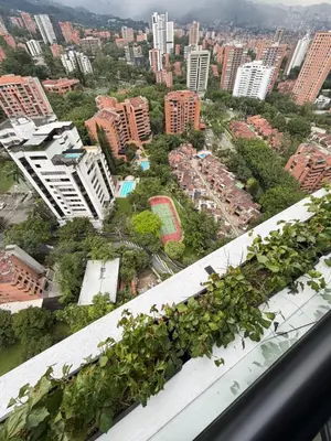 arial view of a city with buildings and trees at Monaco by Top Location City View in Medellín