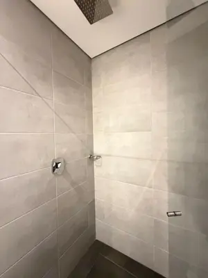 a bathroom with a shower with gray tiles at Monaco by Top Location City View in Medellín