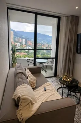 a living room with a couch and a large window at Monaco by Top Location City View in Medellín