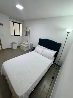 a bedroom with a white bed and a lamp at Apartamento Cocorna Aventura in Cocorná