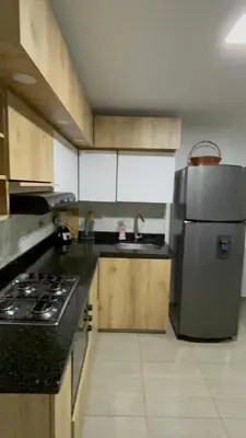 a kitchen with a refrigerator and a sink in it at Apartamento Cocorna Aventura in Cocorná