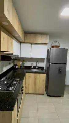 a kitchen with a stainless steel refrigerator and a sink at Apartamento Cocorna Aventura in Cocorná