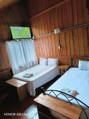 a room with two beds and a window in it at Reserva El Paujil in Puerto Boyacá