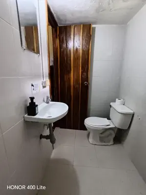a bathroom with a toilet and a sink at Reserva El Paujil in Puerto Boyacá