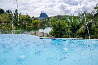 a large swimming pool with a view of a river at Hotel Campestre Santa M de las Aguas in Guatapé