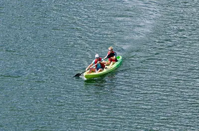 a group of people in a boat in the water at Hotel Campestre Santa M de las Aguas in Guatapé