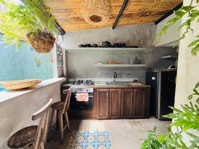 a kitchen with a stove and a sink and a refrigerator at Casa Olivia in Honda