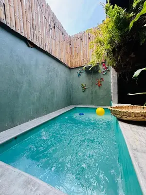 a swimming pool with a fence and a ball in it at Casa Olivia in Honda